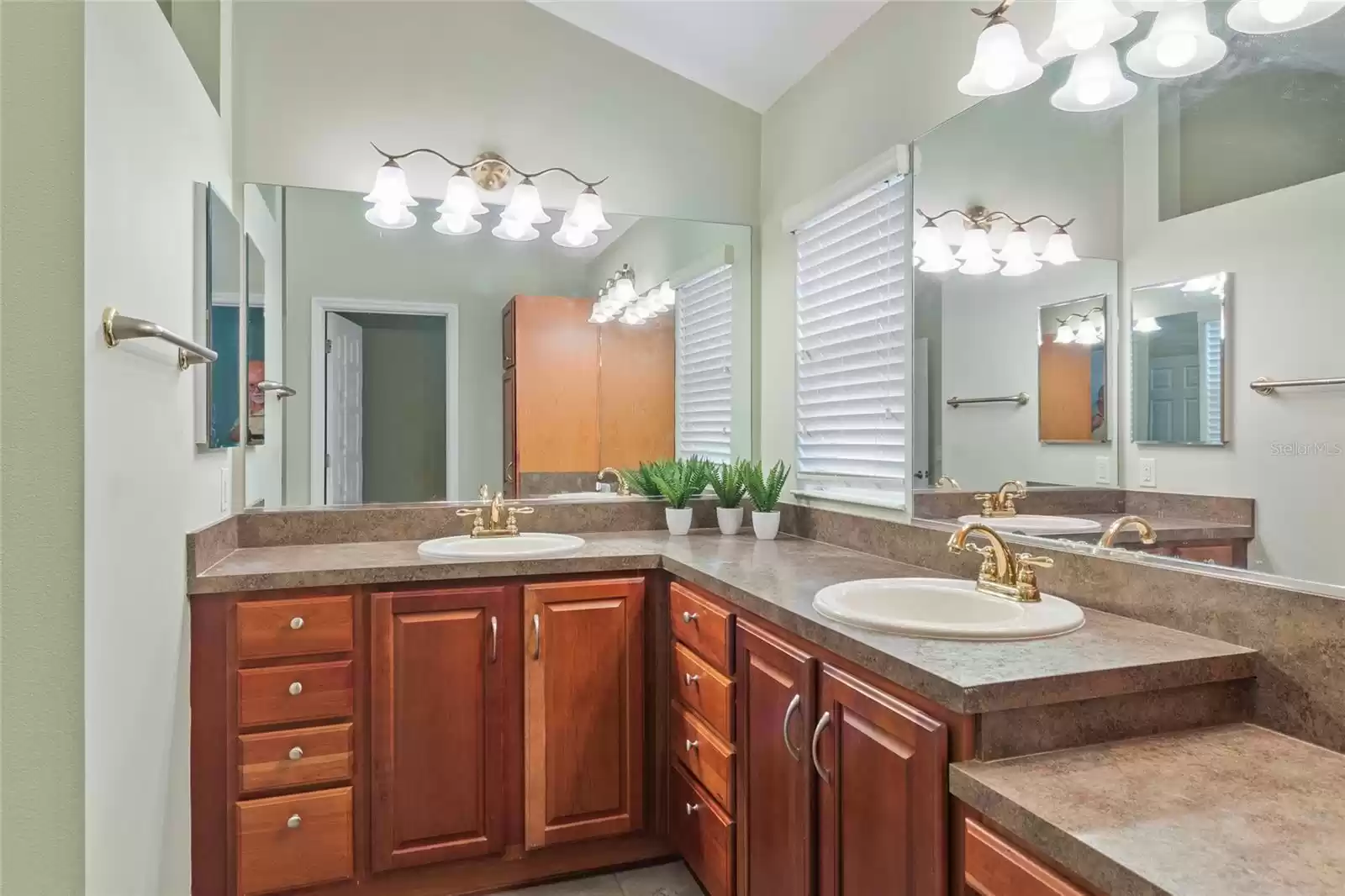 High double vanities with a make up area in this spacious primary bathroom