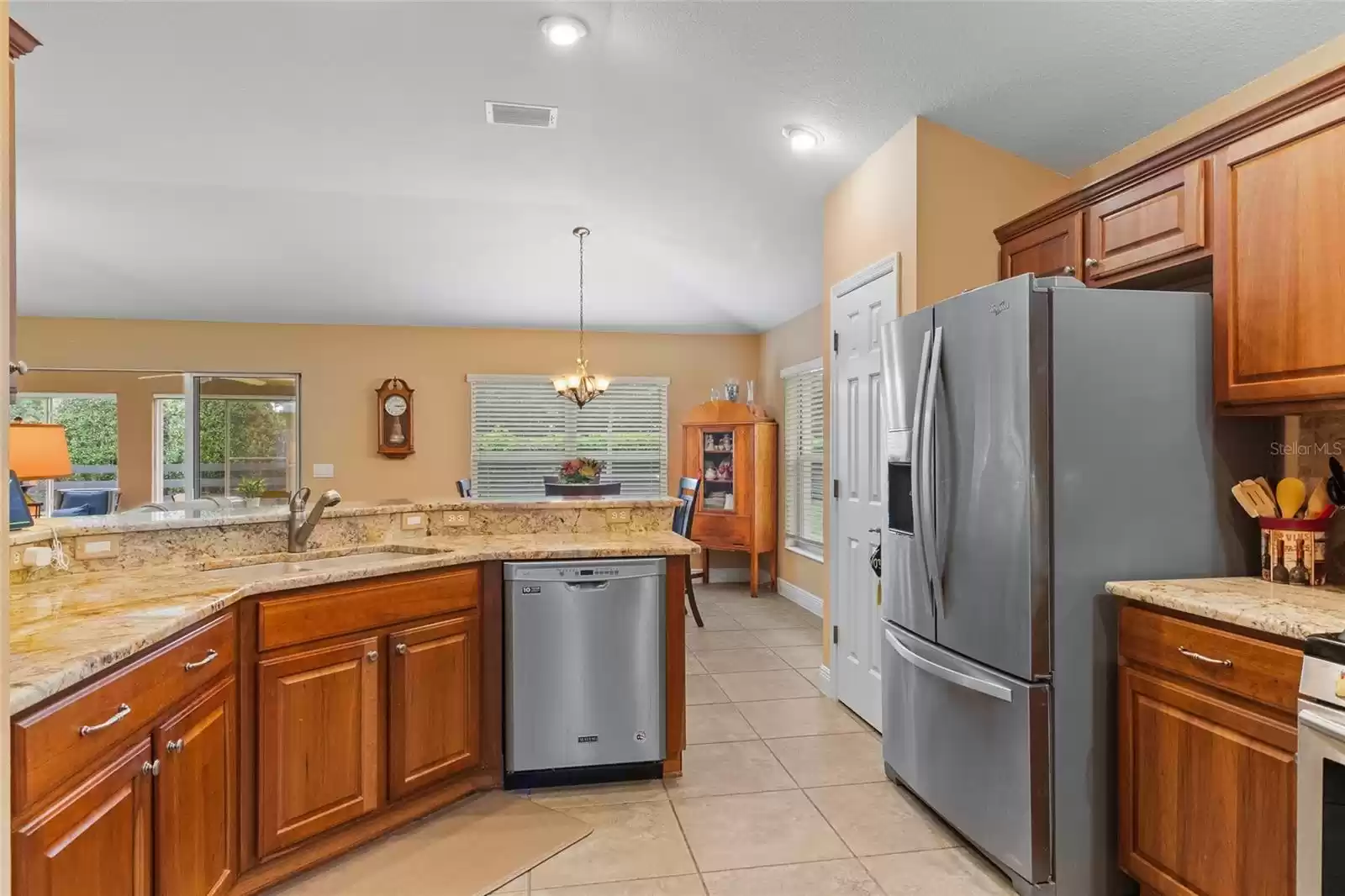 Large kitchen with breakfast bar is open to dinette and living room