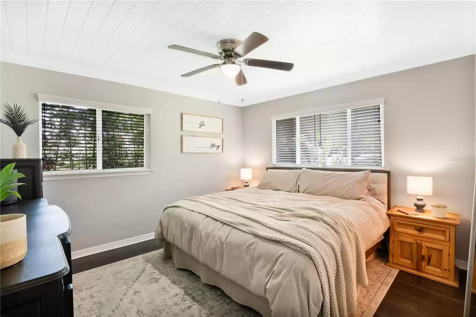 Primary Bedroom with wood floors, shiplap ceiling and plenty of natural light