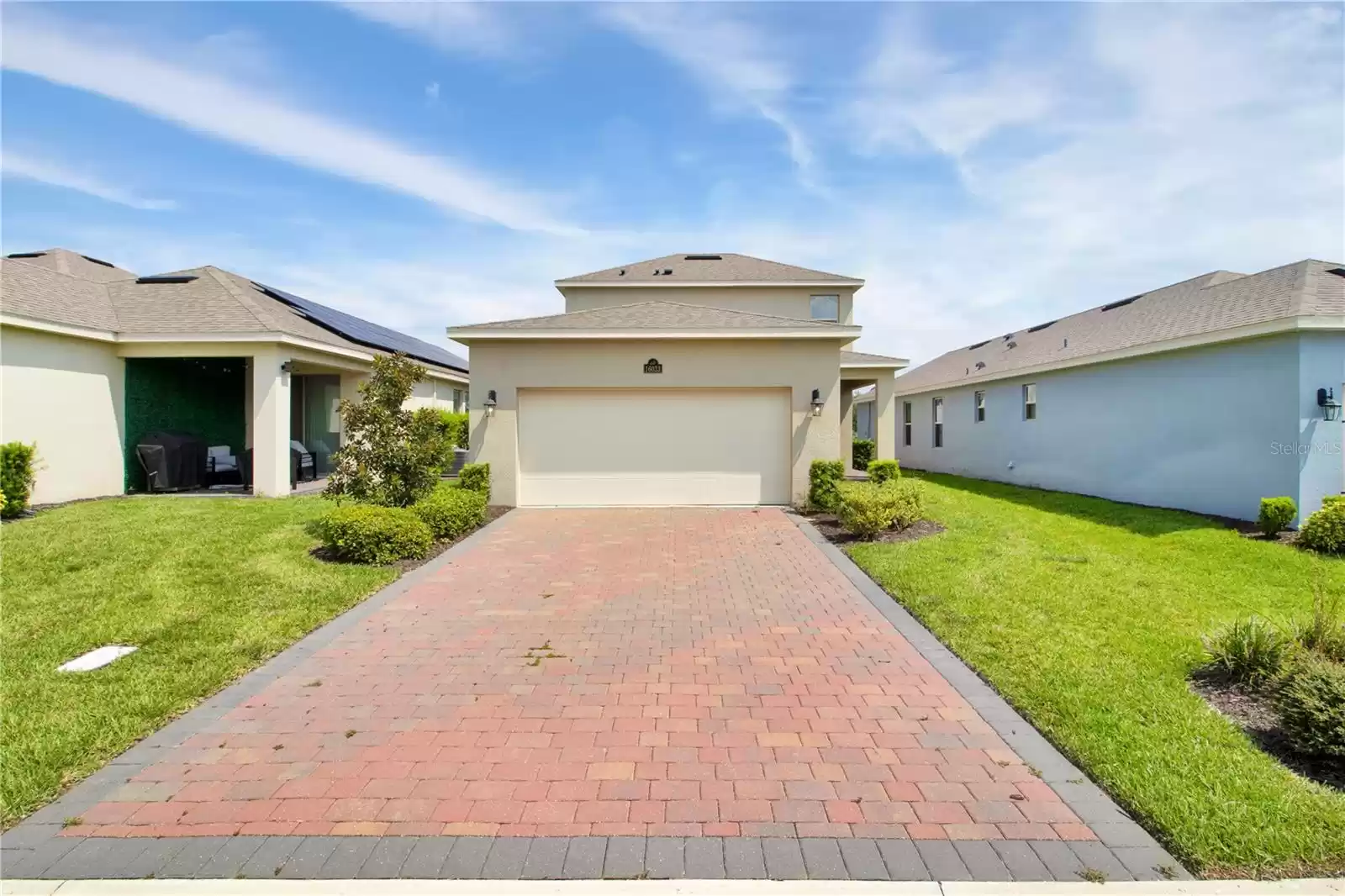 Rear entry garage with paver driveway