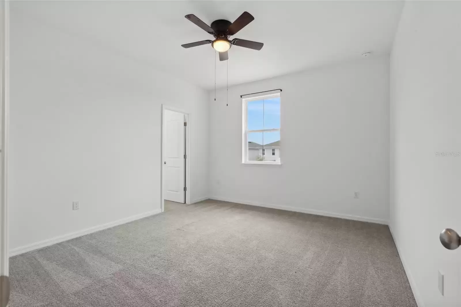 One of the bedrooms on the 2nd floor with large walk in closet and ceiling fan.