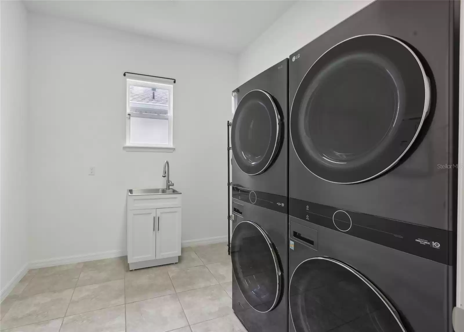 Full laundry room with 2 sets of LG washers and dryers and new laundry sink.