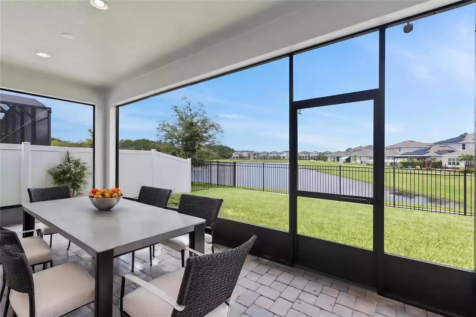 Virtually staged patio.Expansive screened, covered patio the full length of the home with tranquil water view!