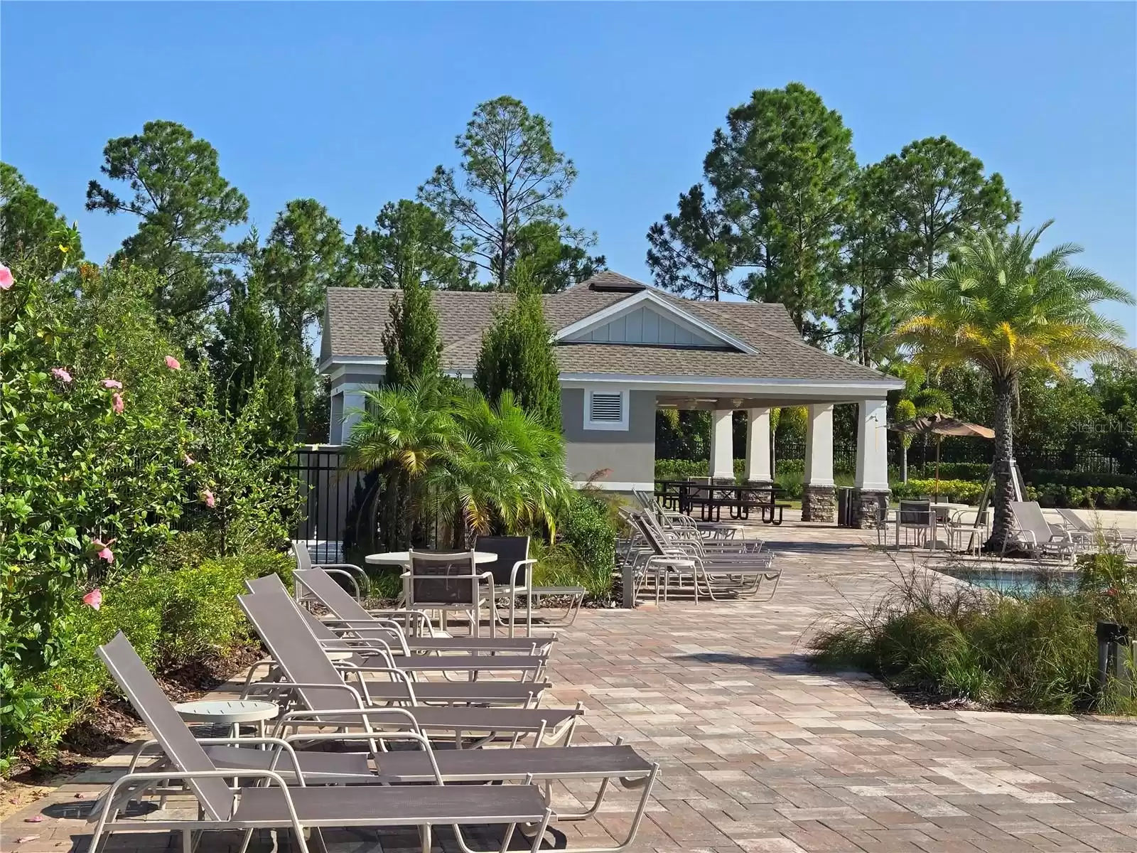 Nice pool deck area with plenty of chairs and covered picnic table area