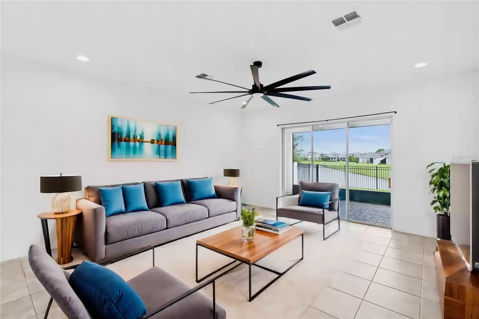 Virtually staged great room. Great room with lovely water views, newer ceiling fan and access to the screened patio overlooking a beautiful water view!