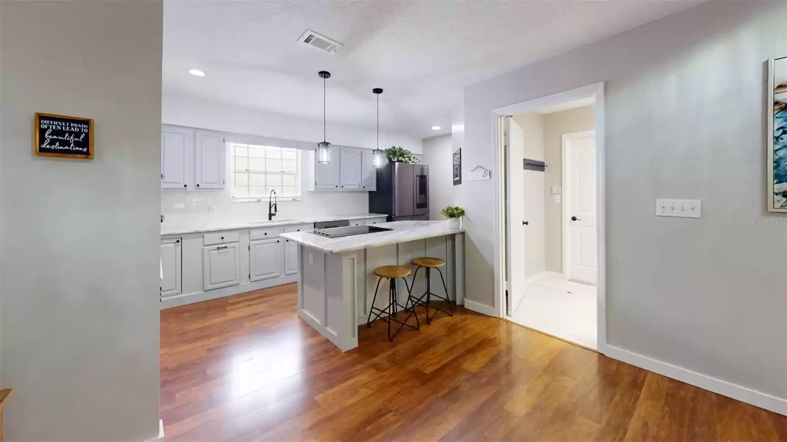 Side view of kitchen, door leads to Laundry Room, then garage