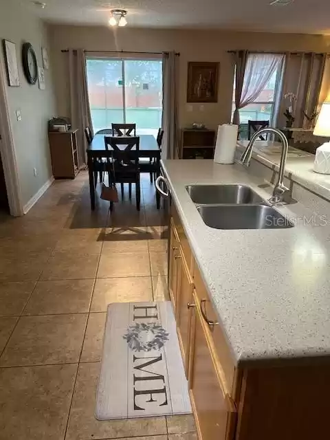 Kitchen overlooking dinette area overlooking the pool and backyard