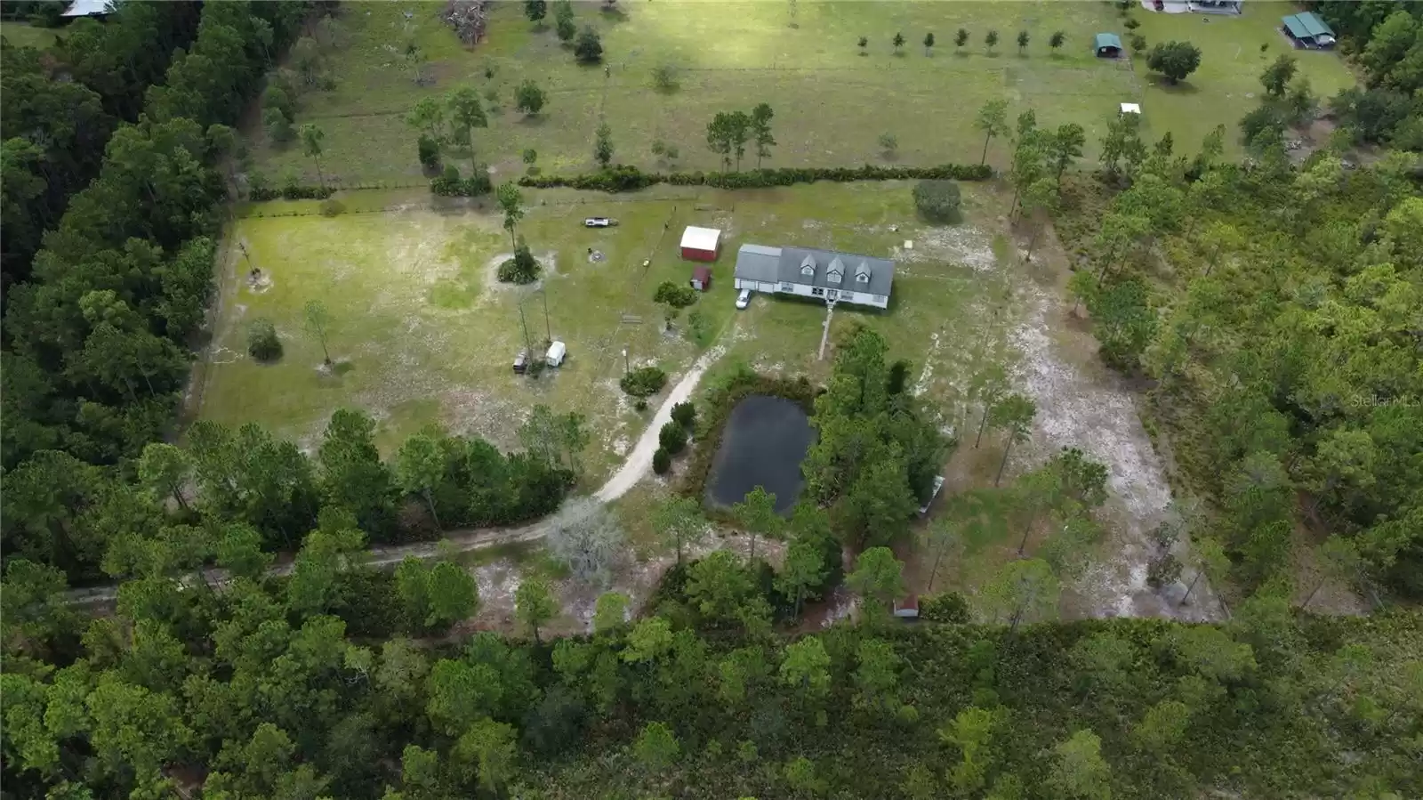 Aerial of half of the Property where the home is located.