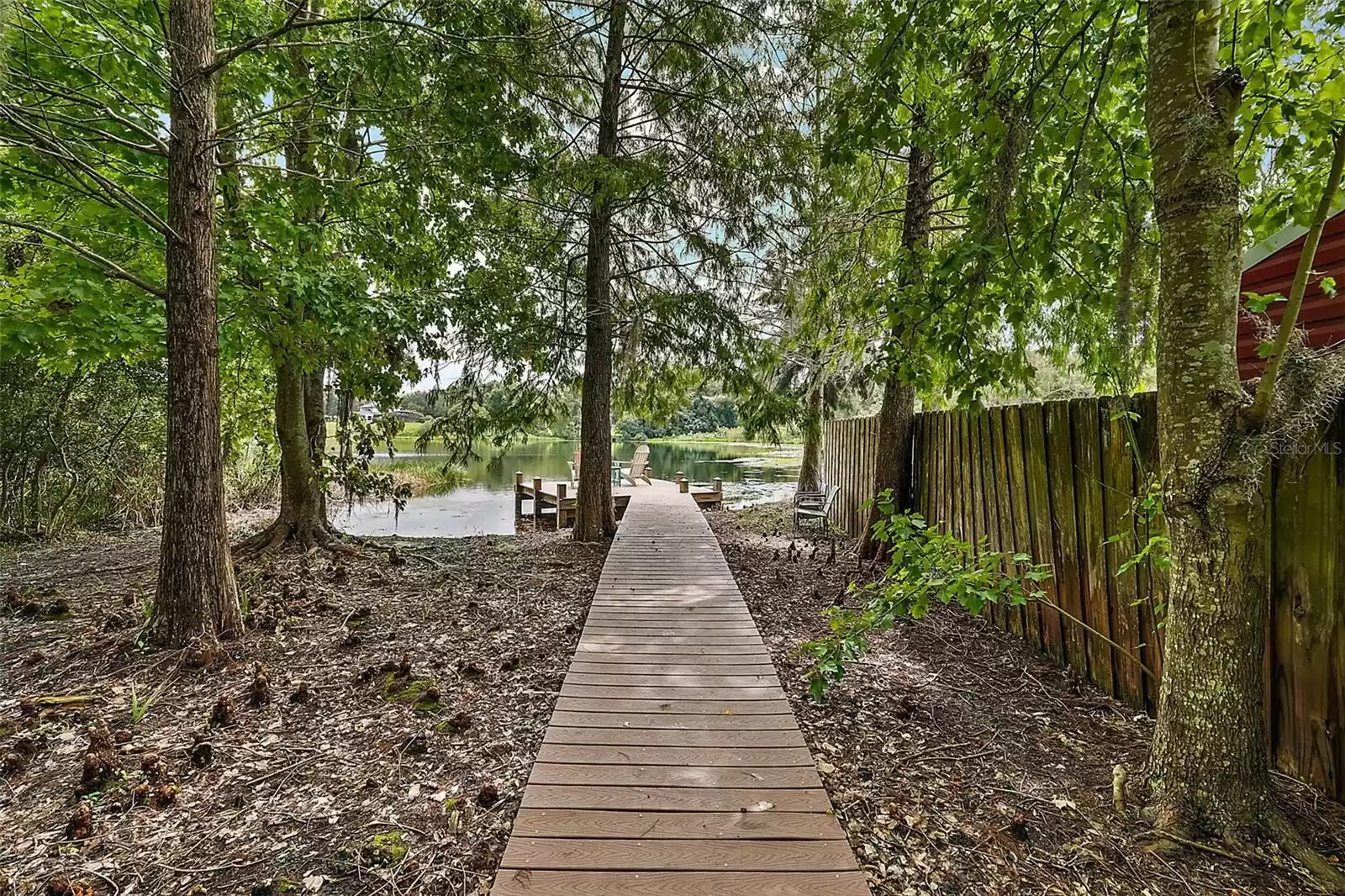 Cypress trees line and shade the Trex boardwalk and dock.