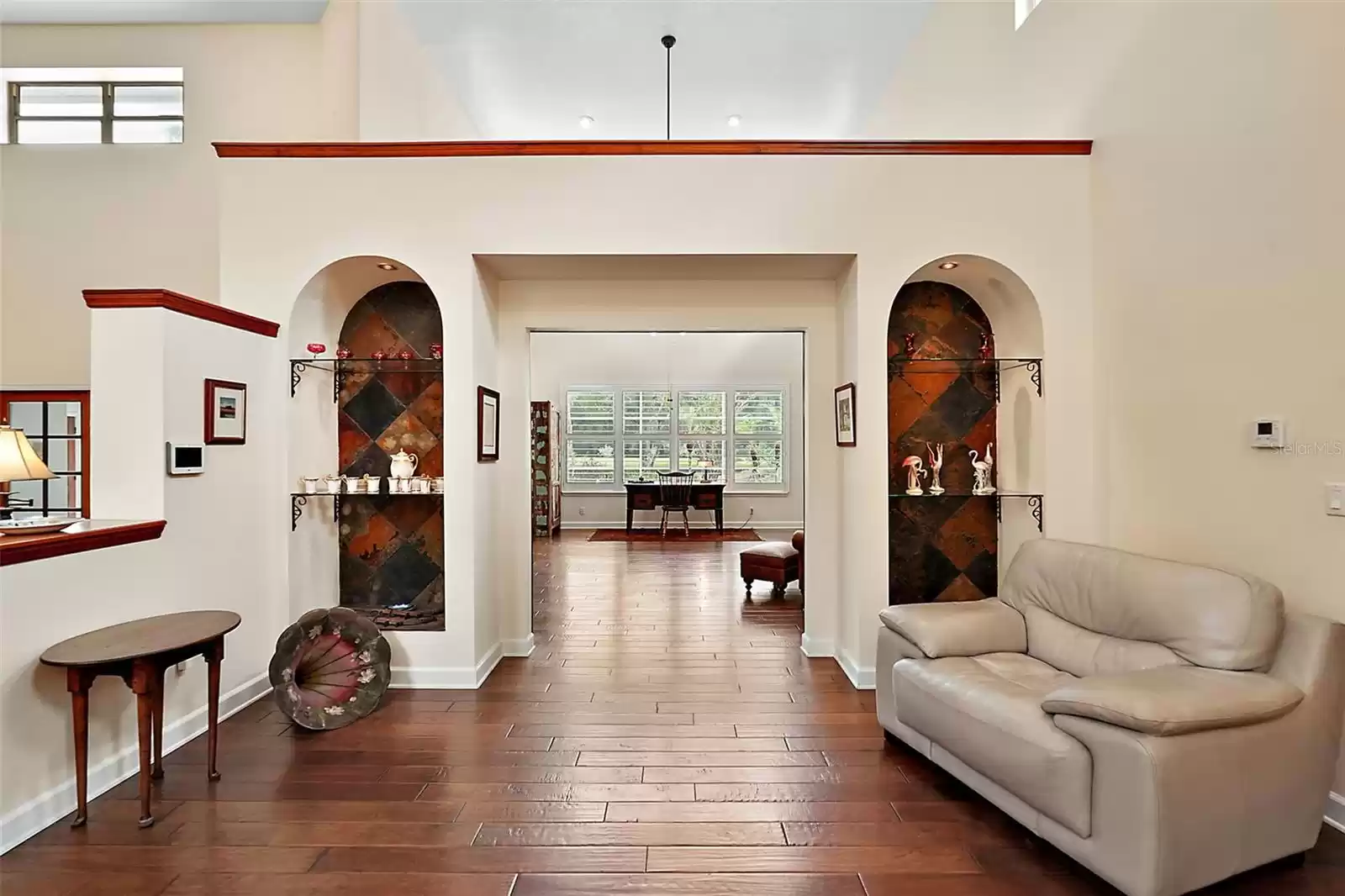 View from the dining room past the built-in, lighted display cabinets into the family room.