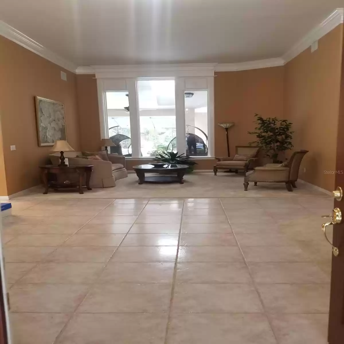 VIEW OF LIVING ROOM AND FOYER FROM FRONT ENTRY DOOR