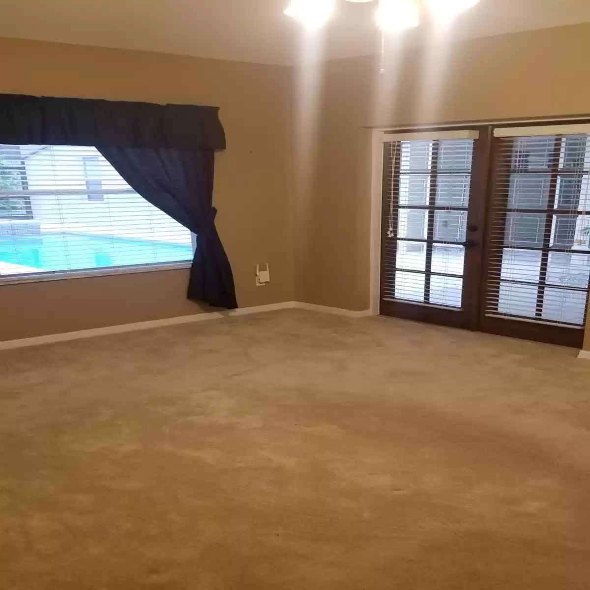 PRIMARY SUITE WITH  VIEW AND DOUBLE FRENCH DOORS LEADING TO THE POOL