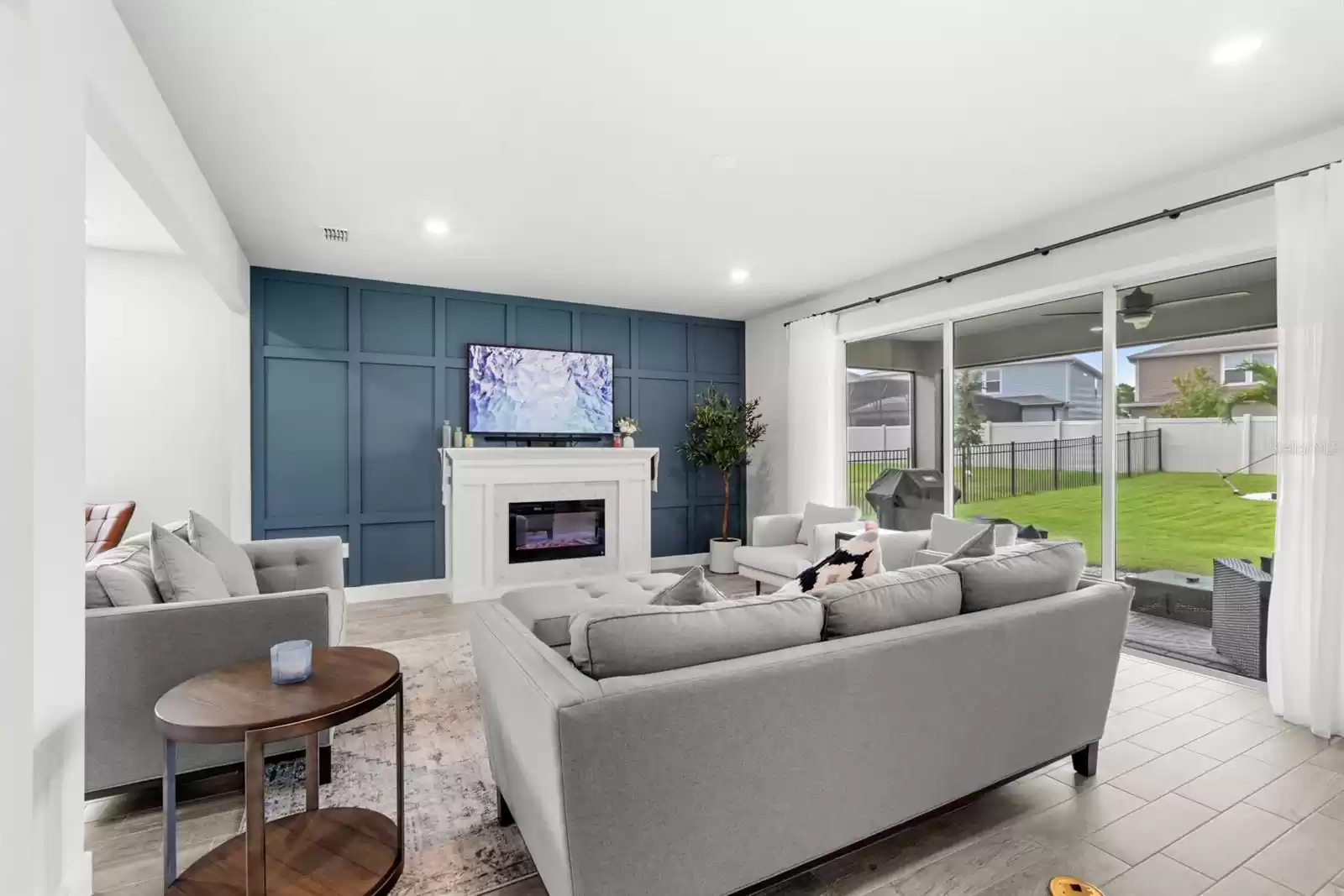 Living room overlooking the pocket sliding glass door and screened-in lanai