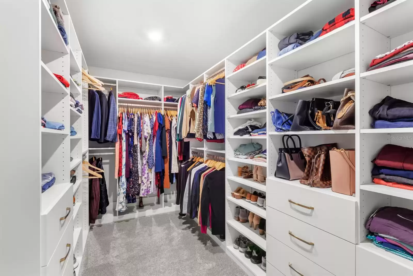 Primary walk-in closet with custom built-ins