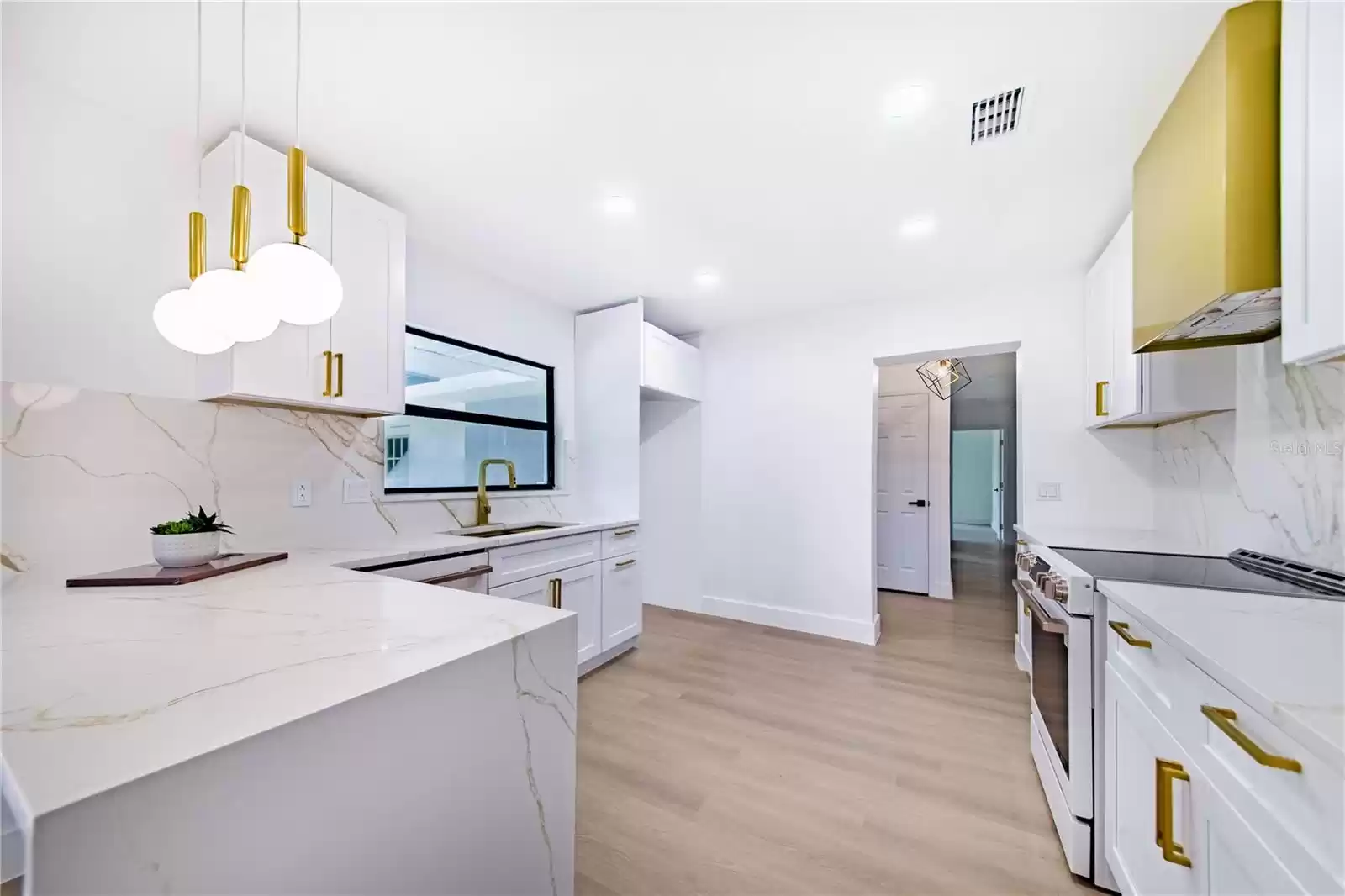 Kitchen Breakfast Bar features a beatiful waterfall leg,  located near the Slider and is open to the Large Living/ Dining Room Combo