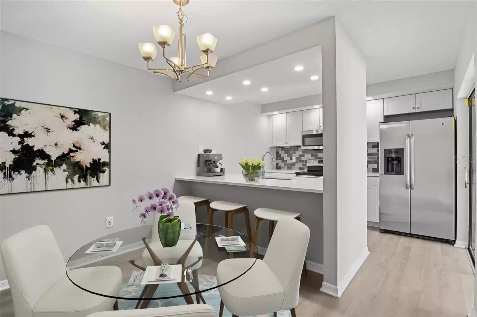 Follow the natural flow into the dining area and updated kitchen, designed with modern elements and keeping the home chef in mind, you will delight in the shaker style cabinetry, NEW STAINLESS STEEL APPLIANCES, stylish subway tile backsplash and stone countertops. Virtually Staged.