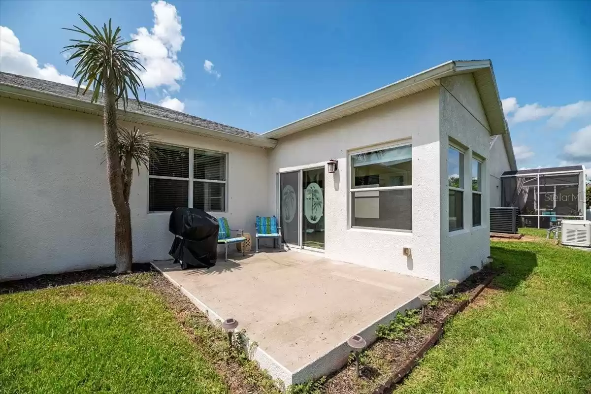 The backyard also features a concrete slab perfect for grilling.