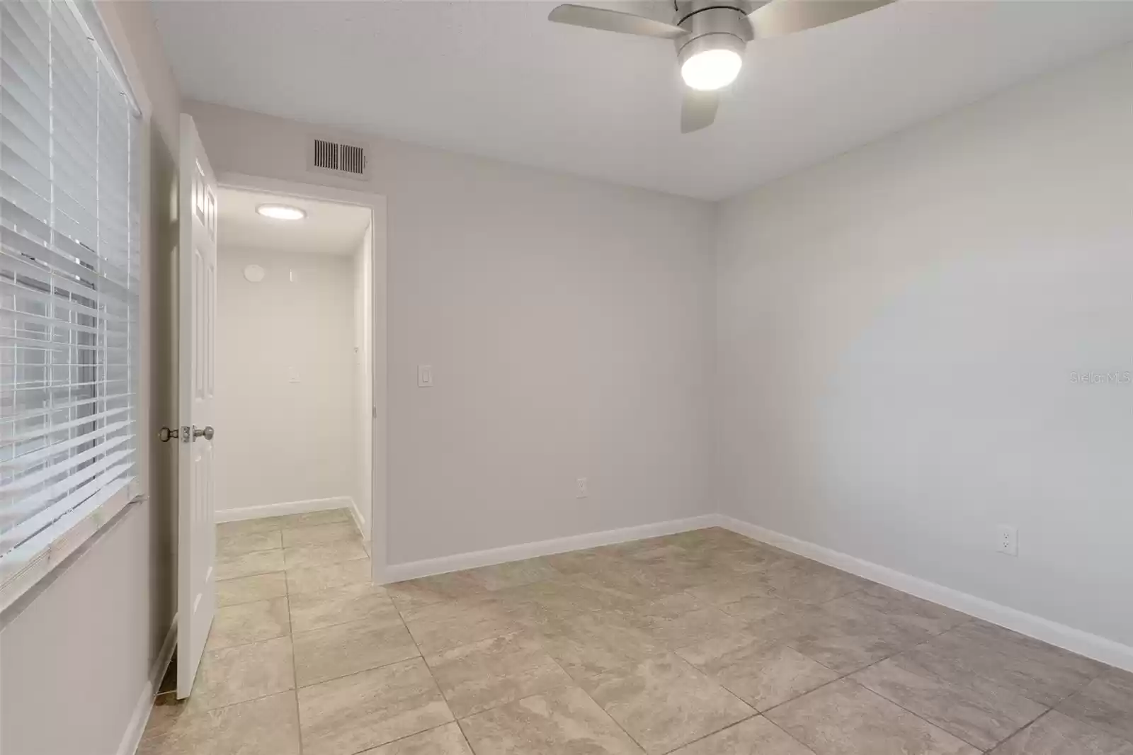 2nd bedroom view into the hallway where 2nd full bath is located.