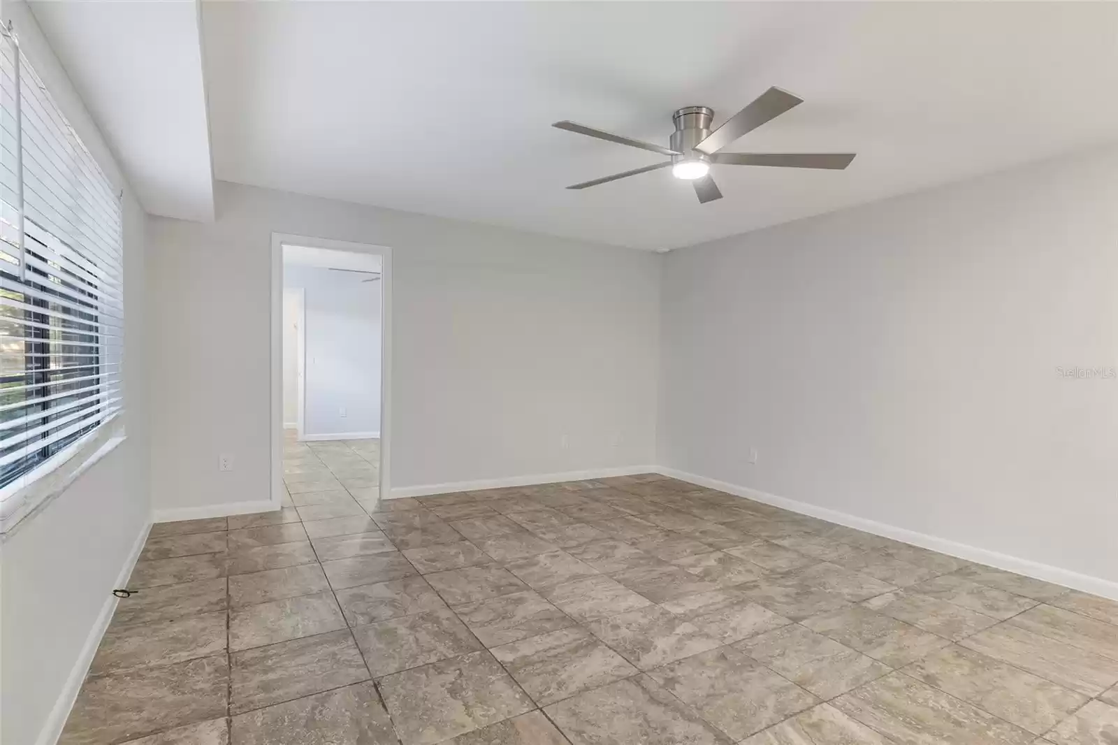 Great room with newly painted walls, ceiling fan!