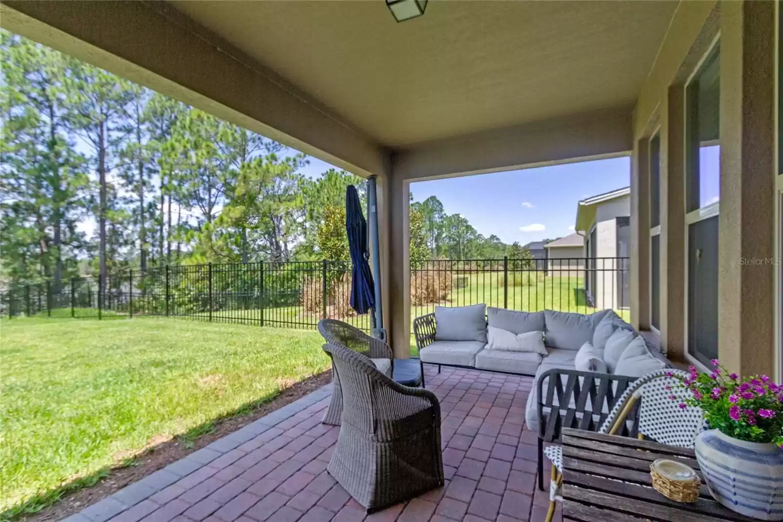 Covered back porch with paver flooring.