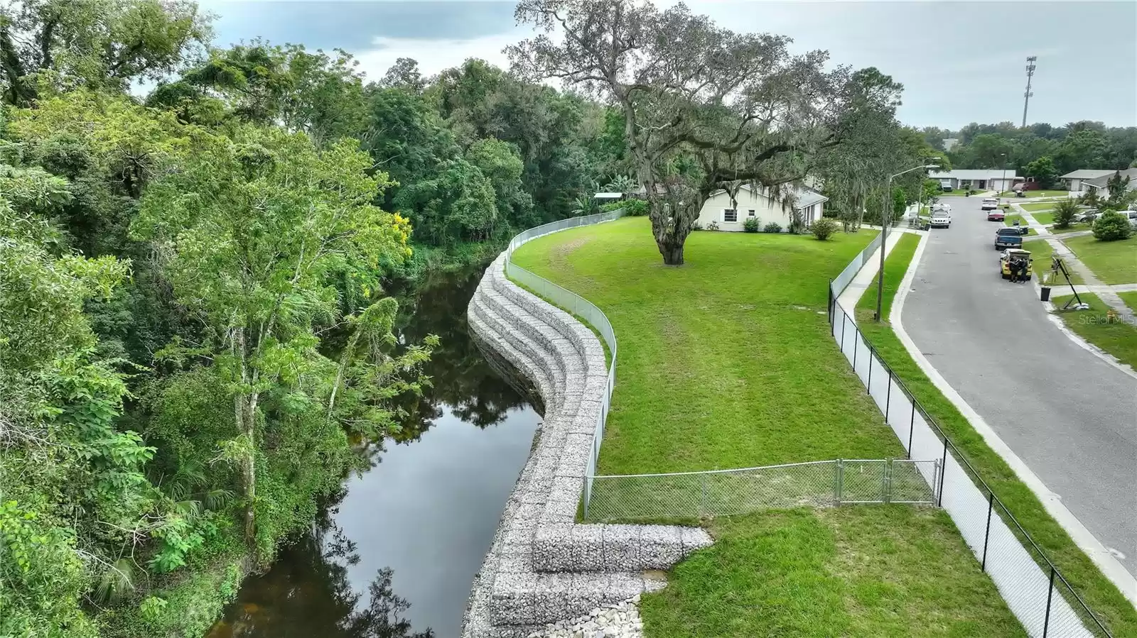 Large fenced yard with Little Wekiva River running behind the property