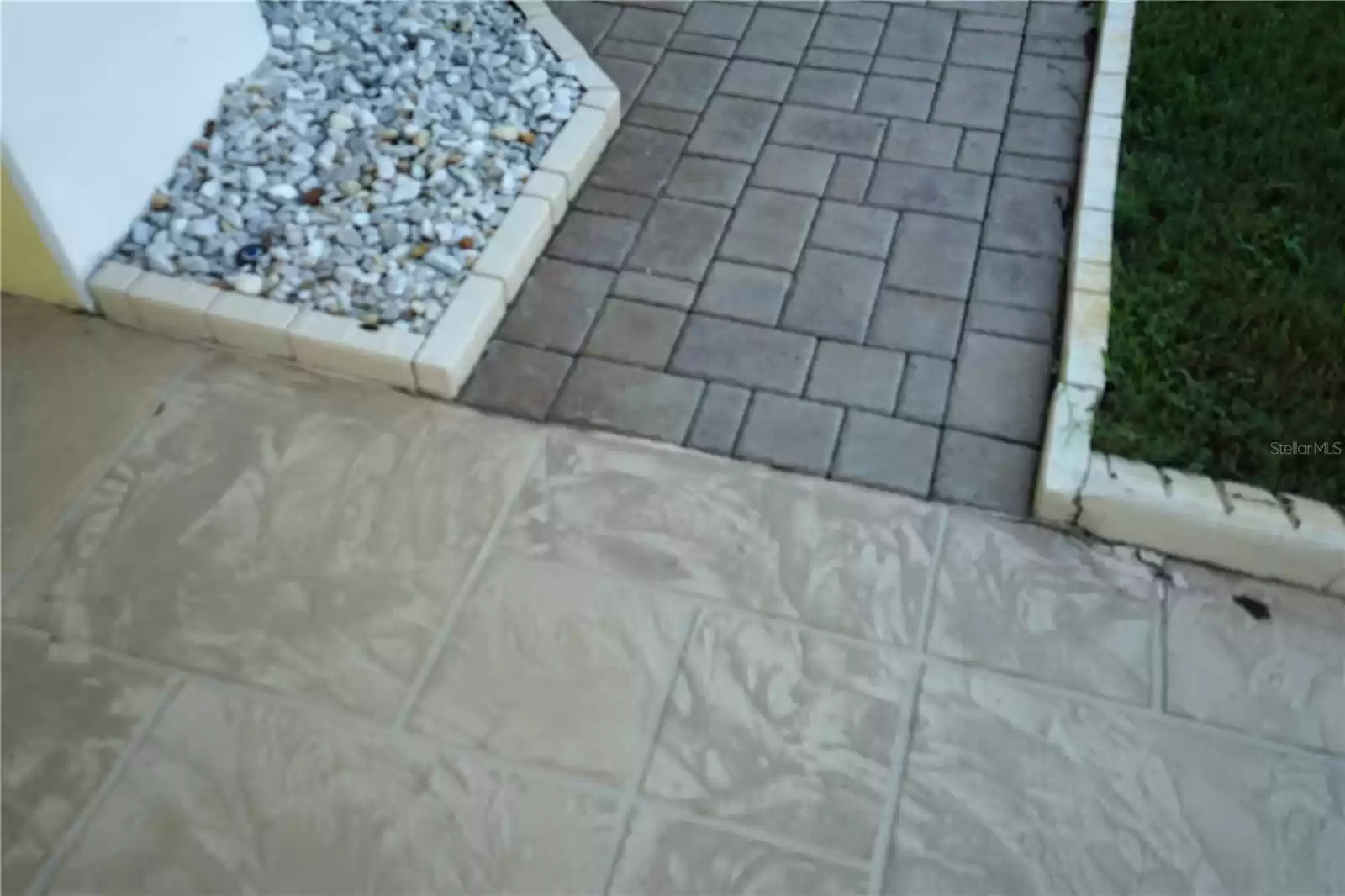 driveway is stamped stone look and sidewalk are bricks