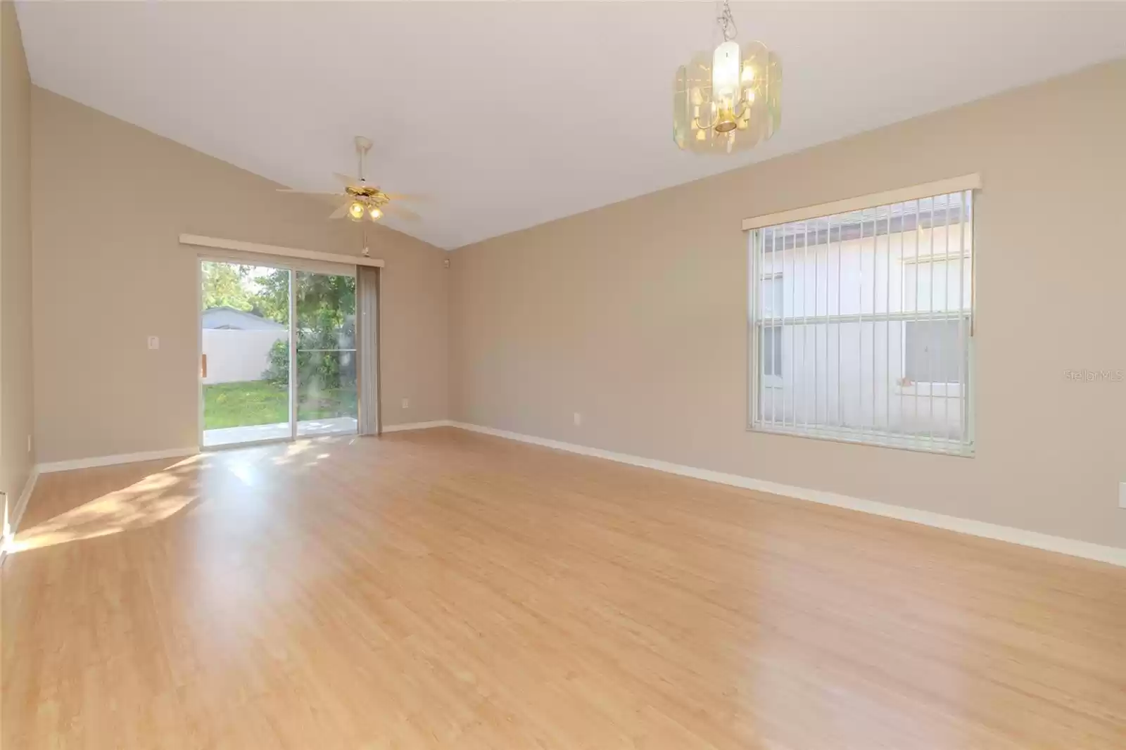 Dining and living room view facing the sliding doors to the backyard