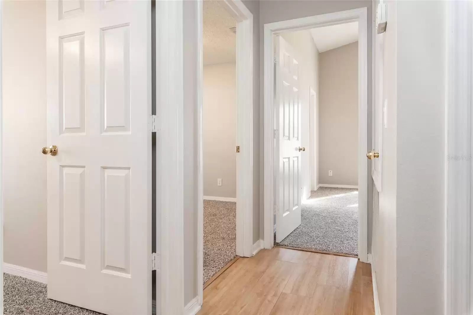 Hallway view facing entry to all 3 bedrooms