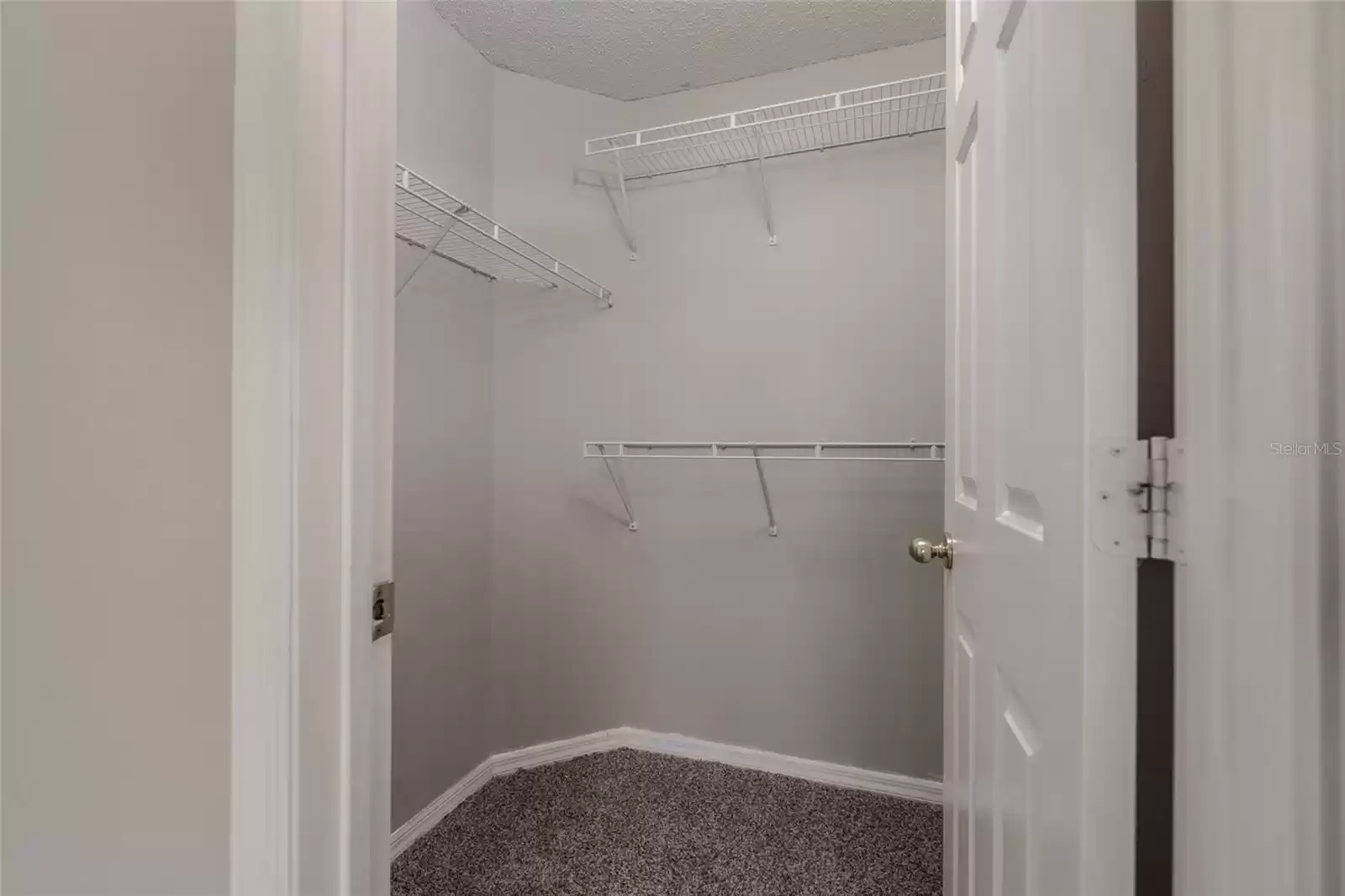 Primary bedroom walk-in closet