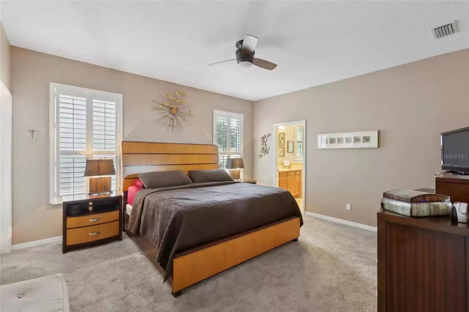 First floor master bedroom with a large walk in closet, ceiling fan and ensuite master bath.