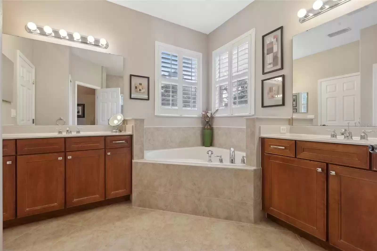 Another view showing both vanities and the large soaking tub.