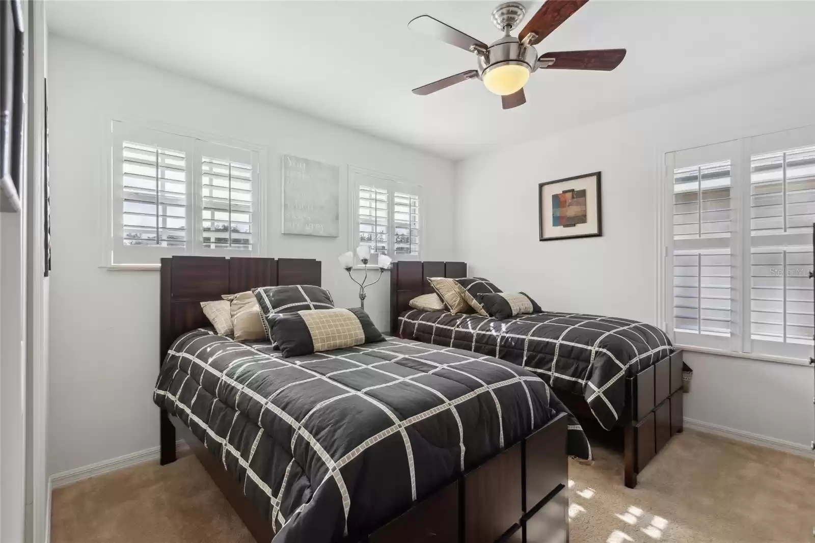 2nd floor first bedroom off the hallway with a ceiling fan and walk in closet.