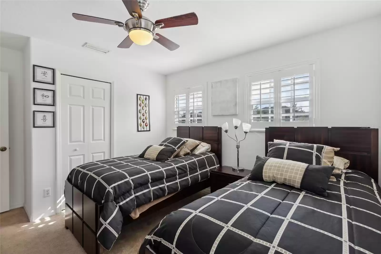 2nd floor first bedroom off the hallway with a ceiling fan and walk in closet.