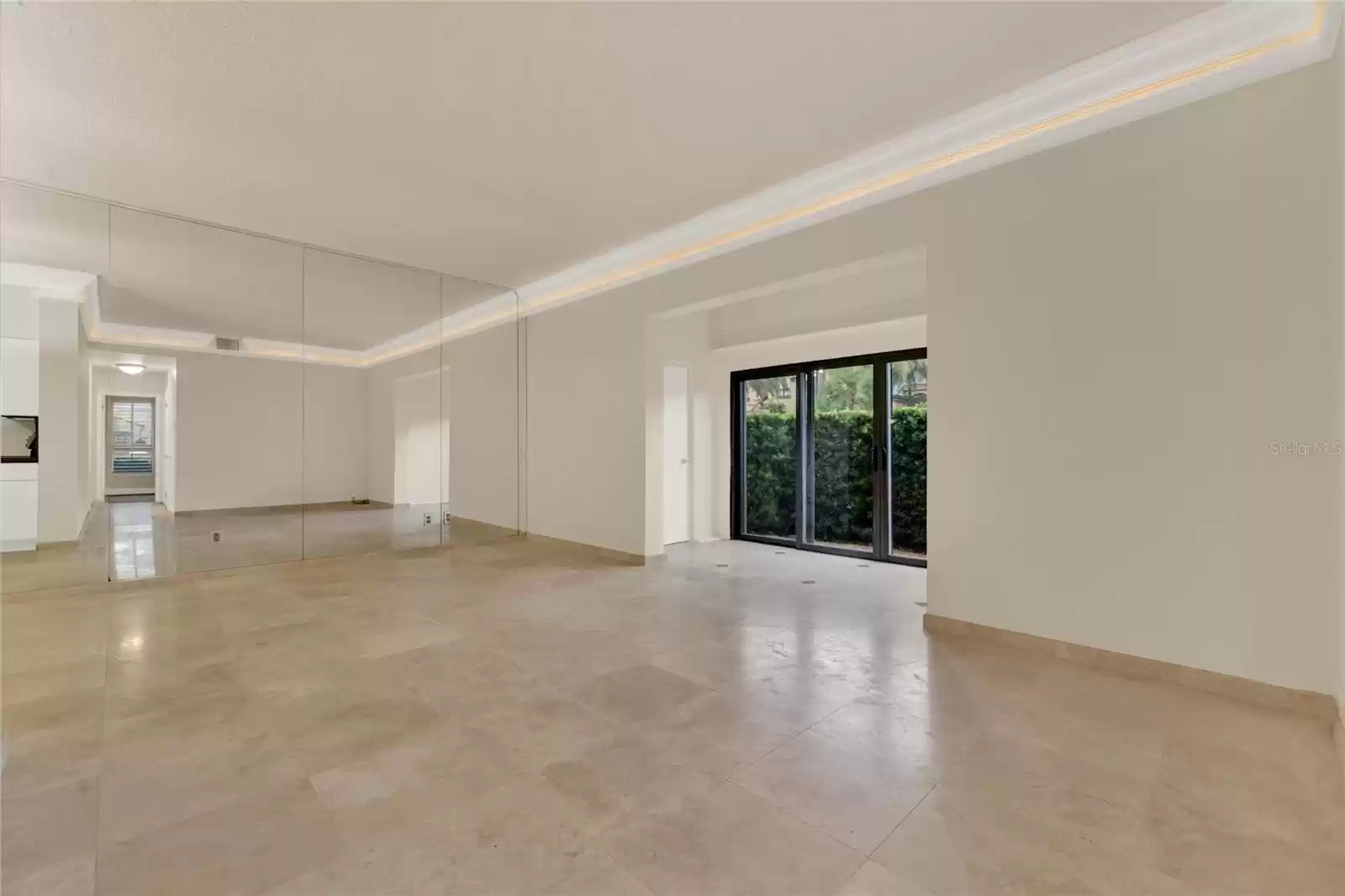 Living room to sunroom and patio view