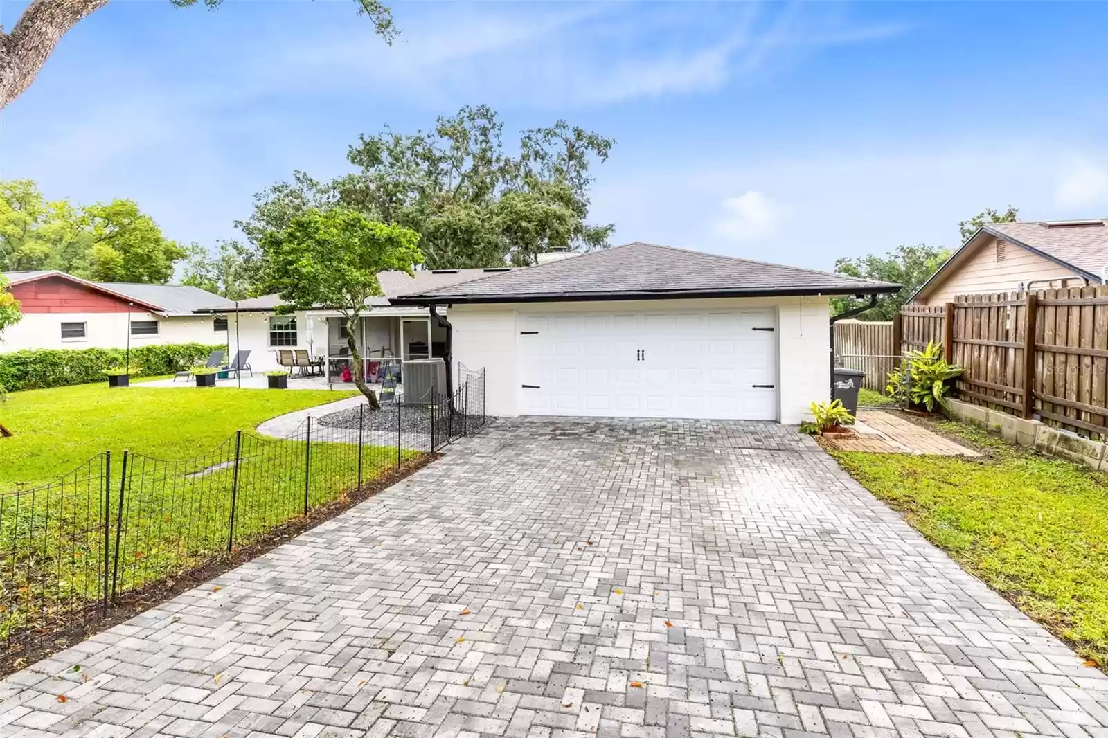 The two-car garage boasts a private rear entrance, also enhanced with new pavers.