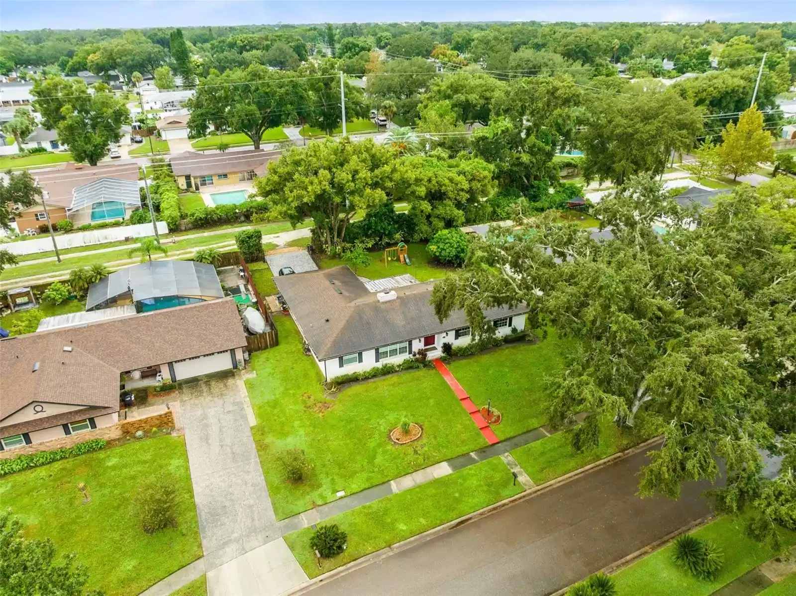 Aerial view of the front of the home and surrounding neighborhood.