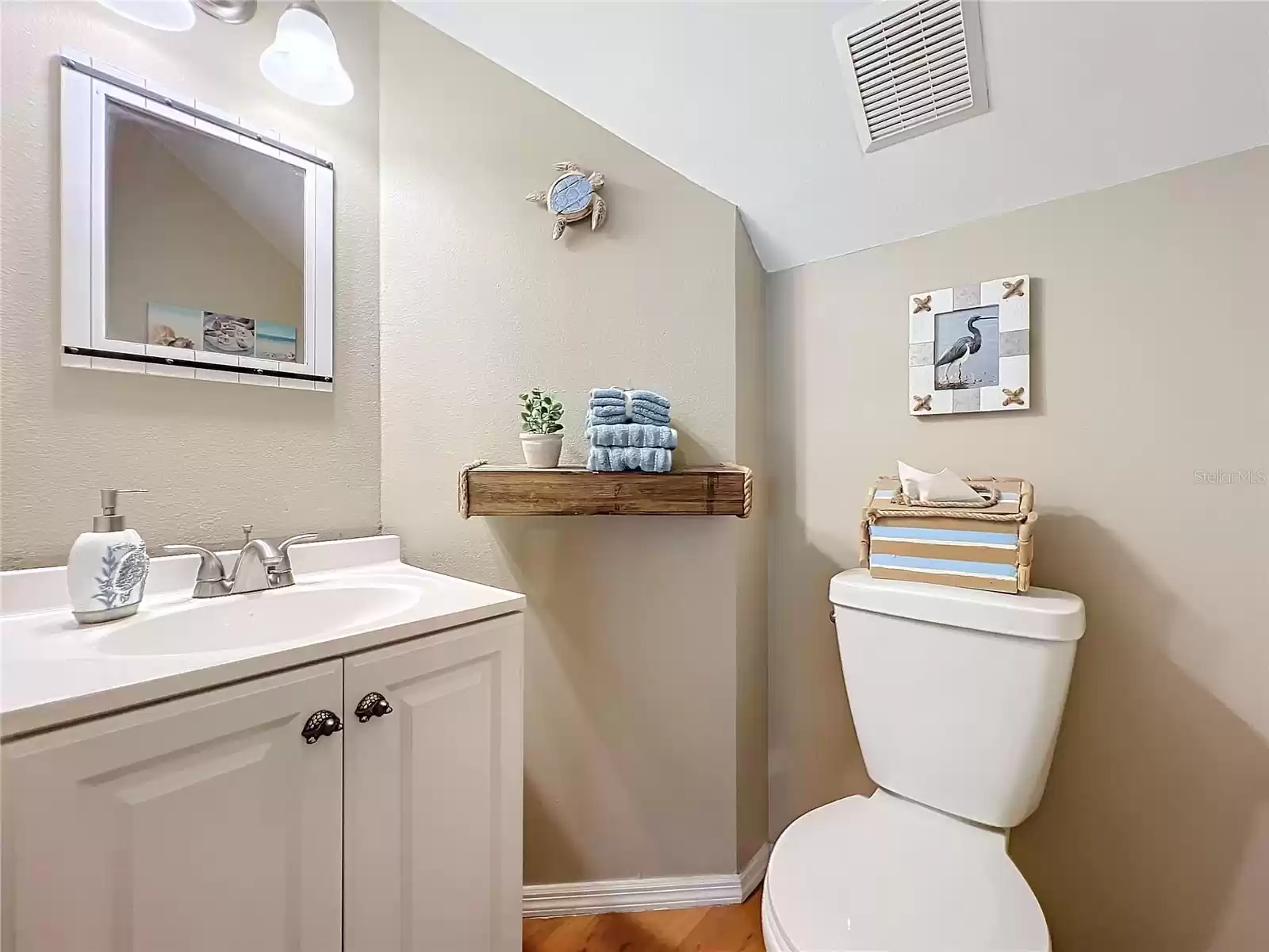 The Half Bath is Under the Staircase for Easy Access and Privacy