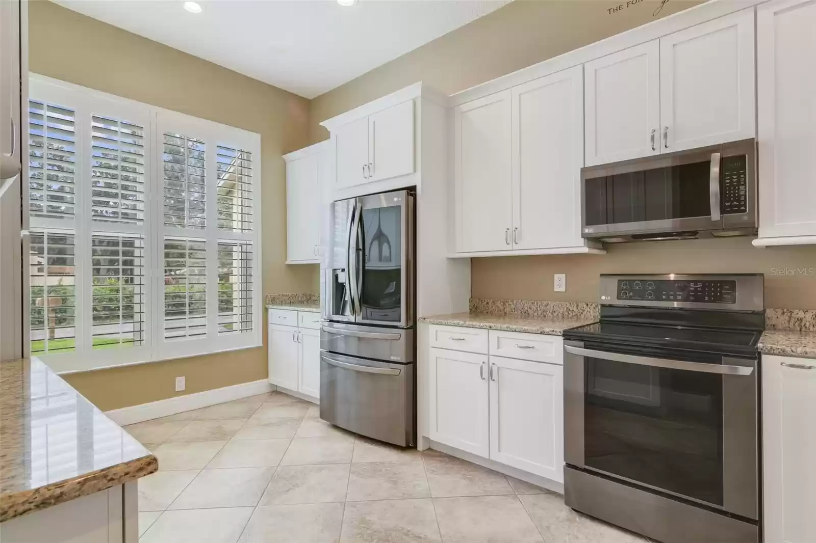 The home chef will appreciate the kitchen makeover now featuring UPGRADED STAINLESS STEEL APPLIANCES, shaker style cabinetry for ample storage, granite countertops and a passthrough breakfast keeps you connected when gathered with family or entertaining guests.