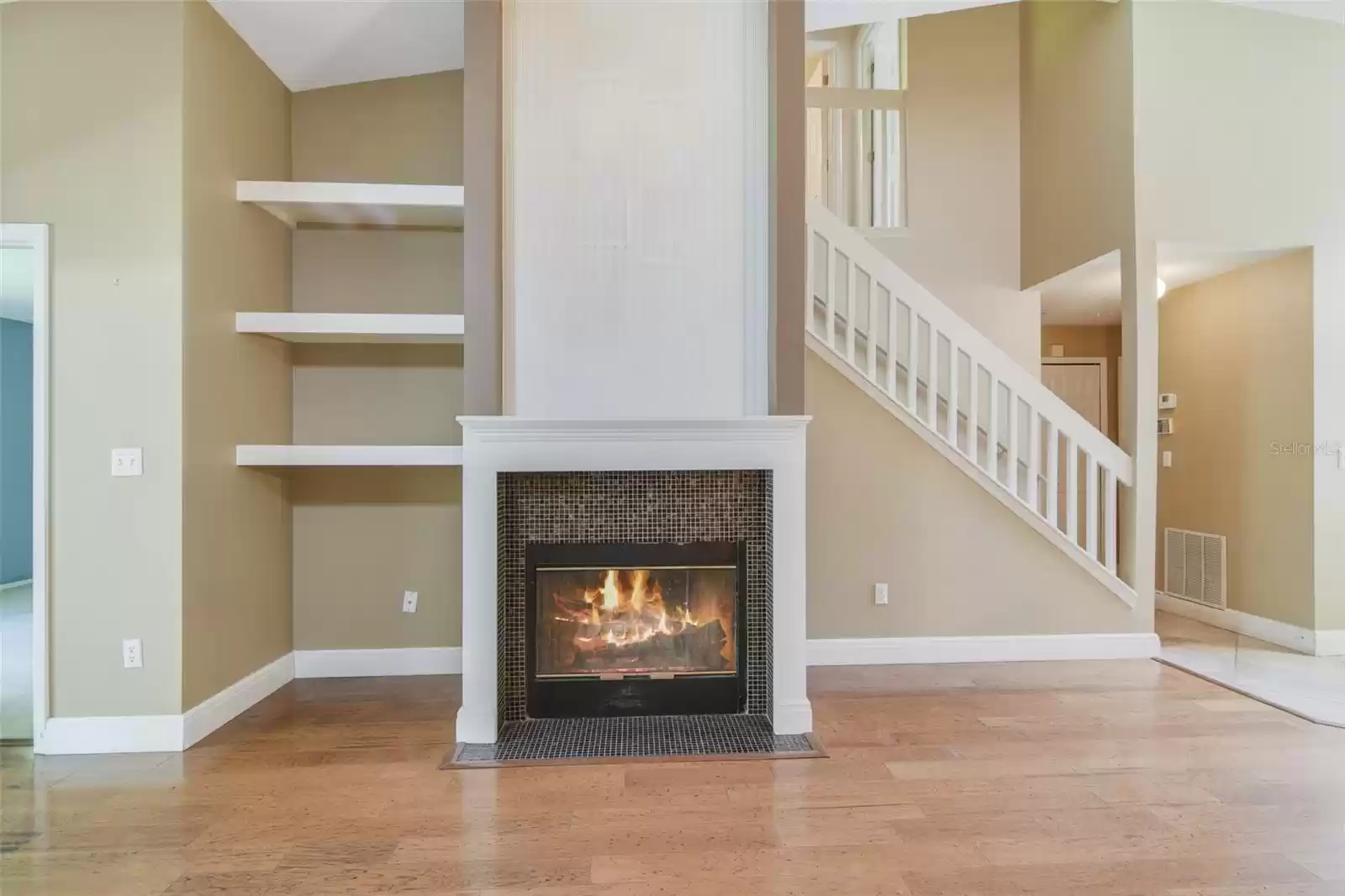 The lovely fireplace and built-in shelving serves as a focal point in your open living/dining.