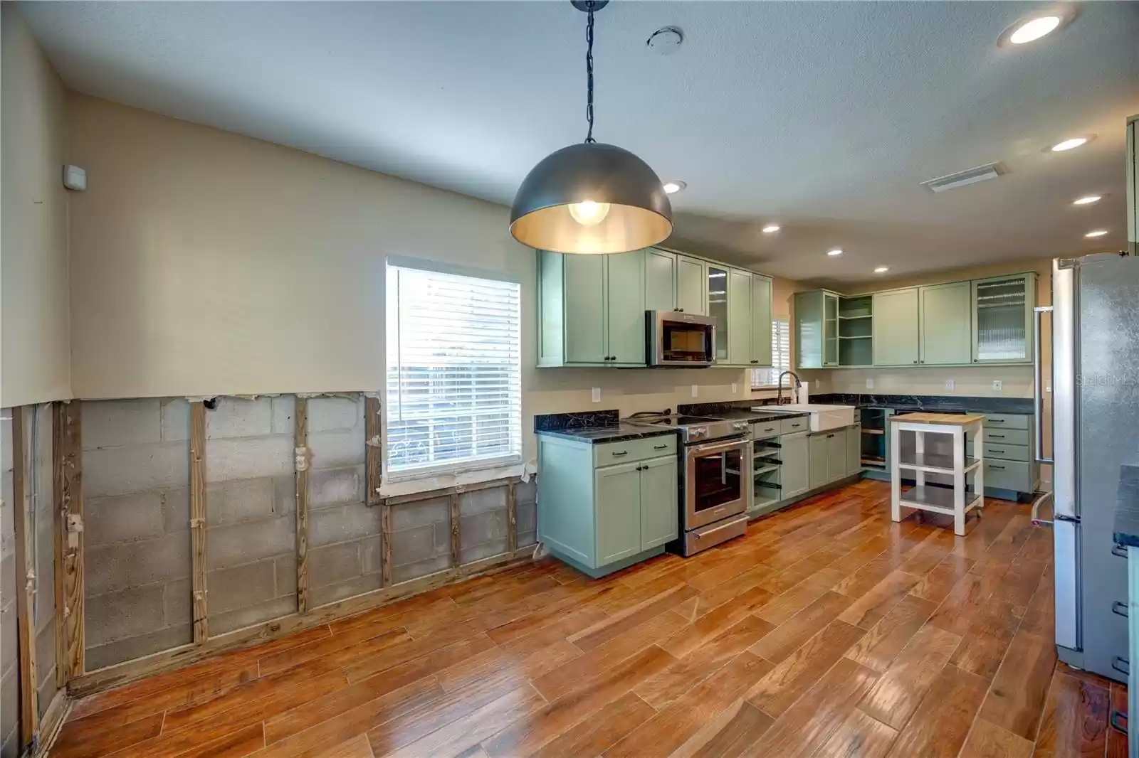 Kitchen with wood like tile floor and soap stone counters!