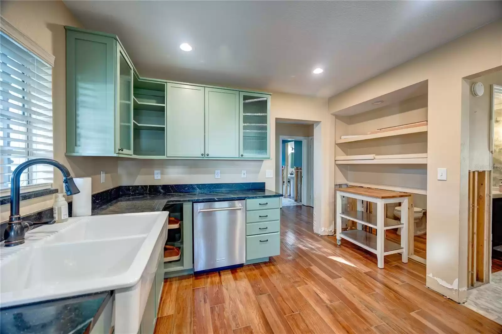 Kitchen with wood like tile floor and soap stone counters!