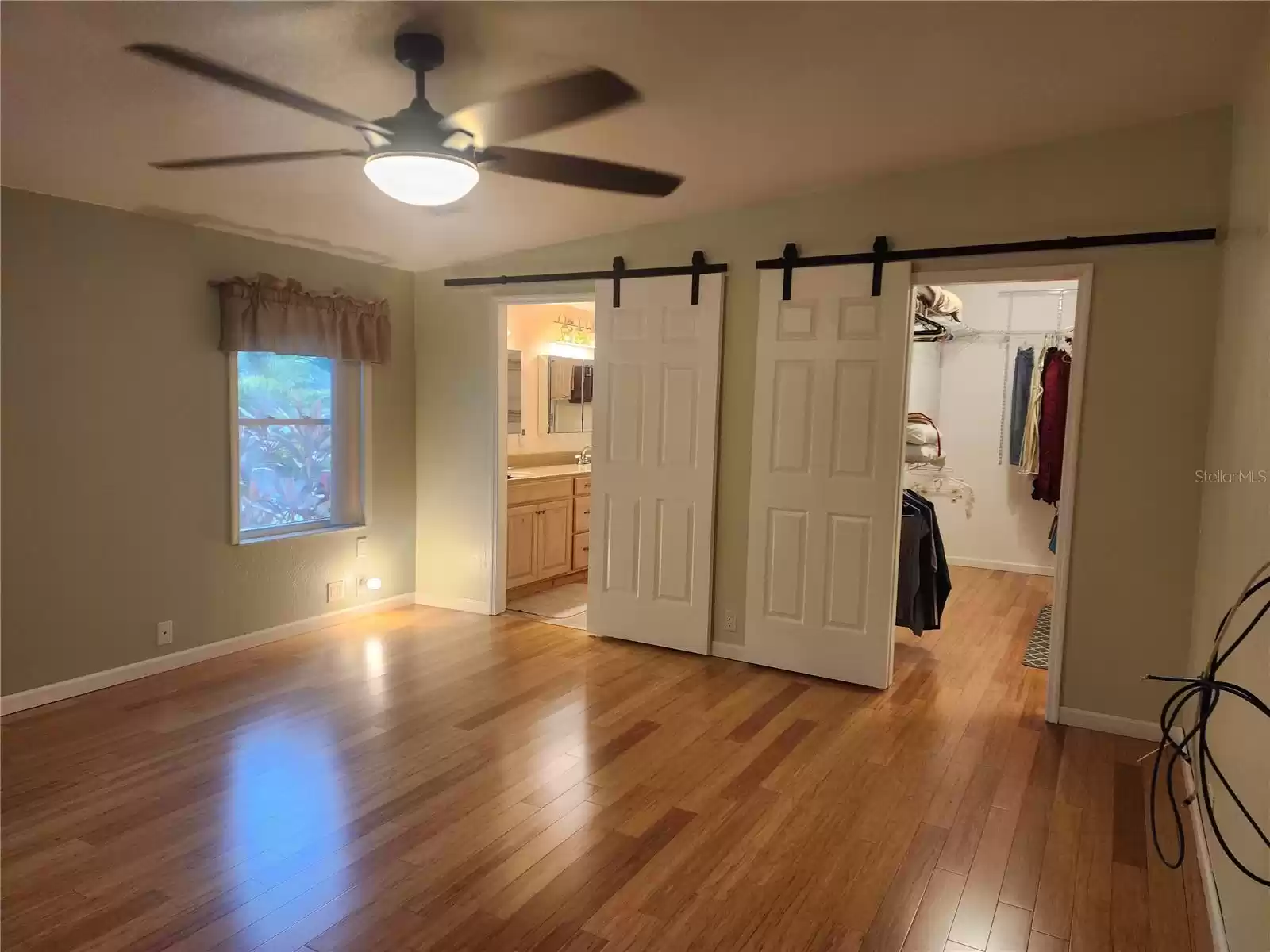 MASTER BEDROOM WITH 2 OF THE 3 BARN DOORS...ONE FOR CLOSET AND OTHER FOR BATH