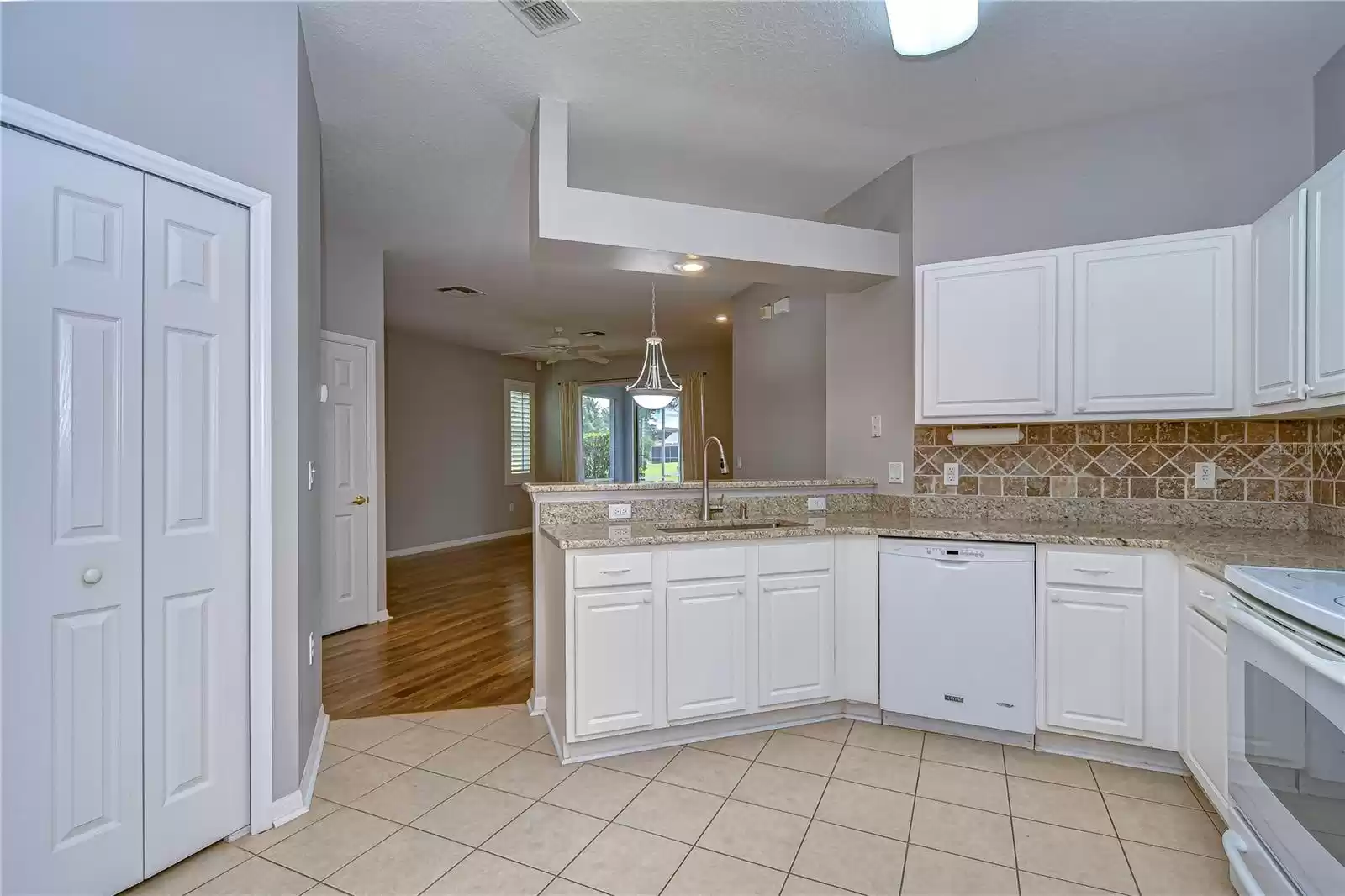 kitchen looking into living room; pantry closet