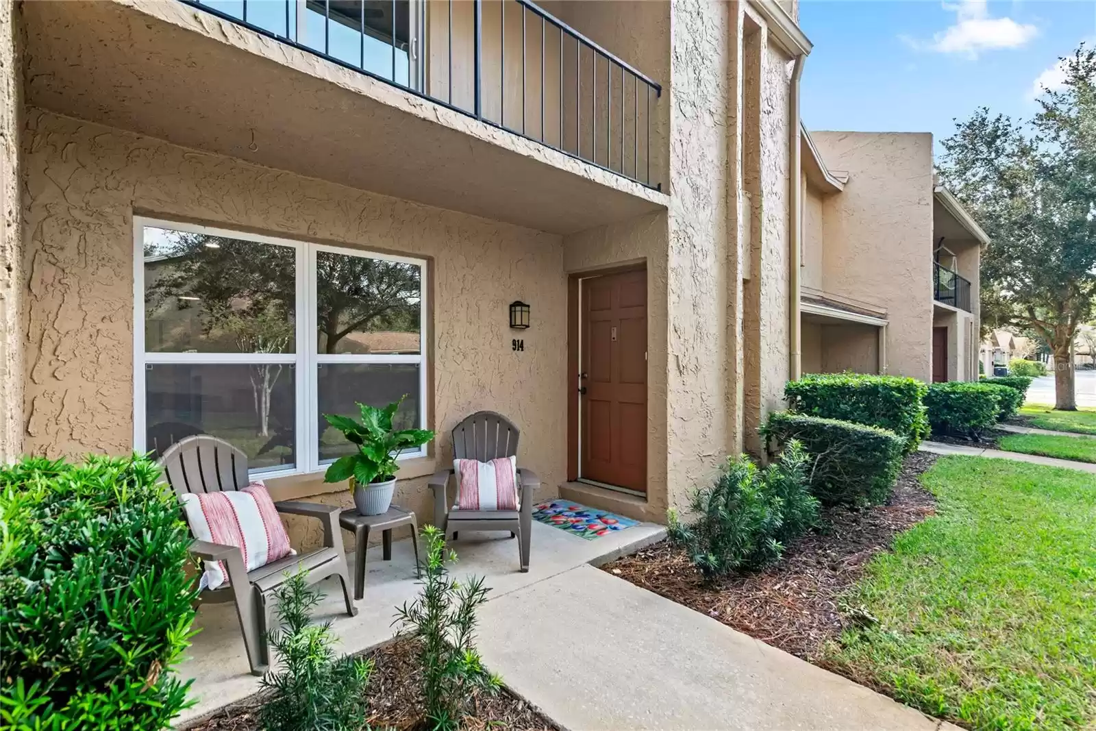 FRONT PORCH OVERLOOKING A PARK LIKE SETTING