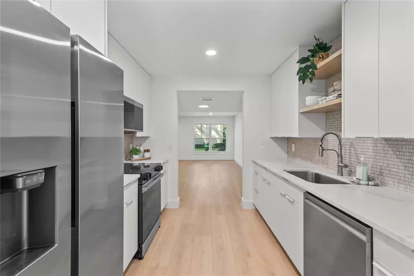 MODERN GALLEY KITCHEN LEADS TO DINING ROOM AND FAMILY ROOM