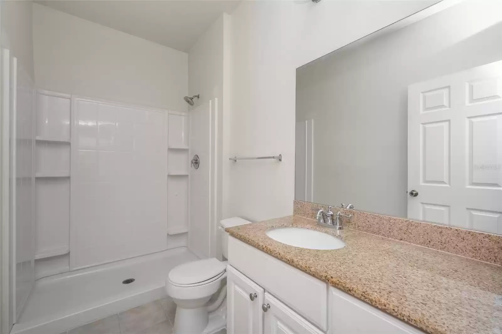 ensuite bathroom with stone countertop