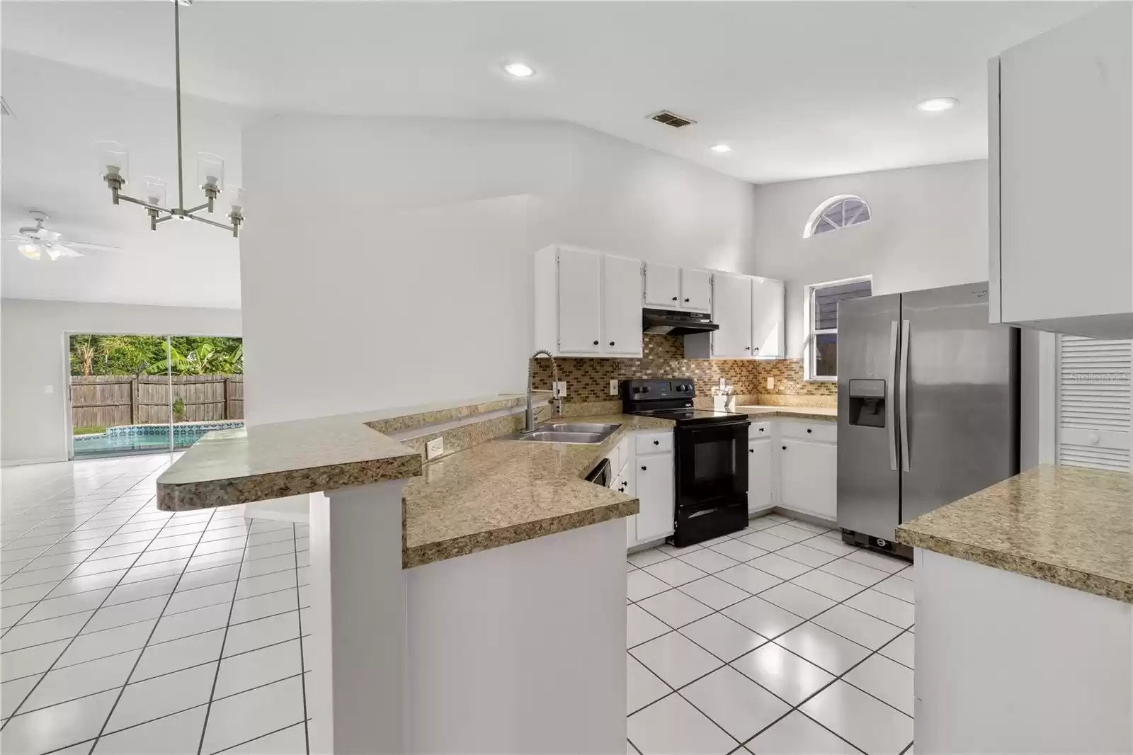 The kitchen is right off of the dining room and foyer and overlooks the living room