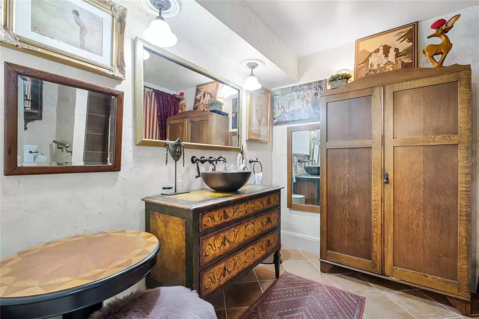 Spacious bathroom with  a shower and an art piece for a sink