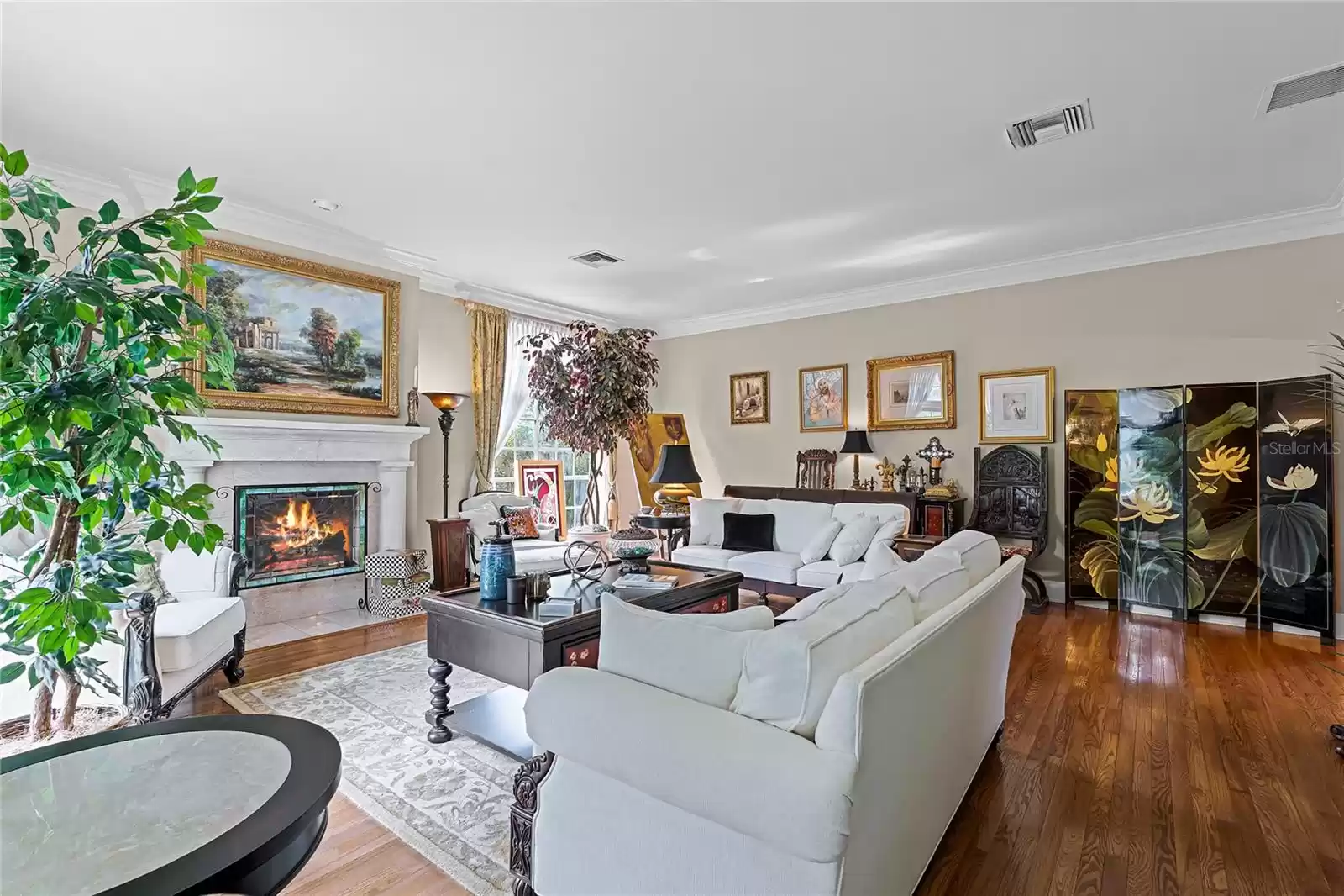 Formal living room with wood burning fireplace