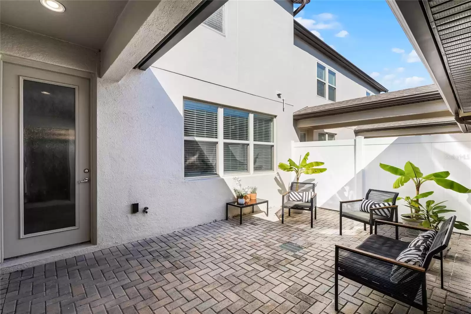 Outdoor courtyard, with a covered walkway to the 2 car garage